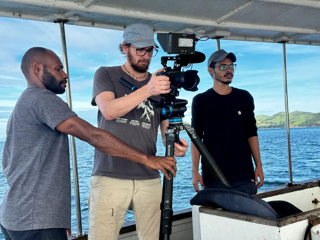 Camera crew filming on a boat